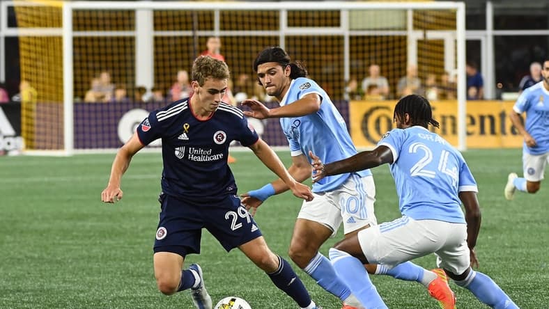 Sep 4, 2022; Foxborough, Massachusetts, USA; New England Revolution midfielder Noel Buck (29) defends the ball from New York City defender Tayvon Gray (24) during the first half at Gillette Stadium. Mandatory Credit: Eric Canha-USA TODAY Sports