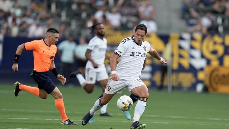 Sep 4, 2022; Carson, California, USA; LA Galaxy forward Javier Hernandez (14) kicks the ball against Sporting Kansas City in the first half at Dignity Health Sports Park. Mandatory Credit: Kirby Lee-USA TODAY Sports