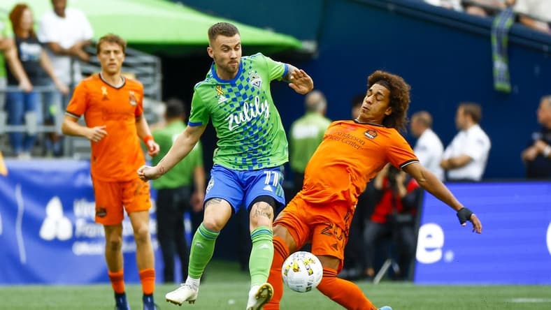 Sep 4, 2022; Seattle, Washington, USA; Seattle Sounders FC midfielder Albert Rusnak (11) and Houston Dynamo midfielder Adalberto Carrasquilla (20) collide in pursuit of a pass during the first half at Lumen Field. Mandatory Credit: Joe Nicholson-USA TODAY Sports