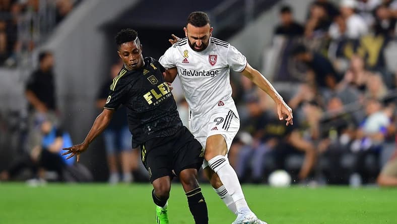Sep 4, 2022; Los Angeles, California, USA; Los Angeles FC forward Latif Blessing (7) plays for the ball against Real Salt Lake forward Justin Meram (9) during the second half at Banc of California Stadium. Mandatory Credit: Gary A. Vasquez-USA TODAY Sports