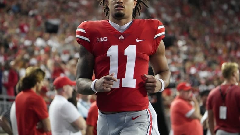 Sep 3, 2022; Columbus, Ohio, USA;  Ohio State Buckeyes wide receiver Jaxon Smith-Njigba (11) runs on the sideline after taking a hard hit during the NCAA football game against the Notre Dame Fighting Irish at Ohio Stadium. Mandatory Credit: Adam Cairns-USA TODAY Sports