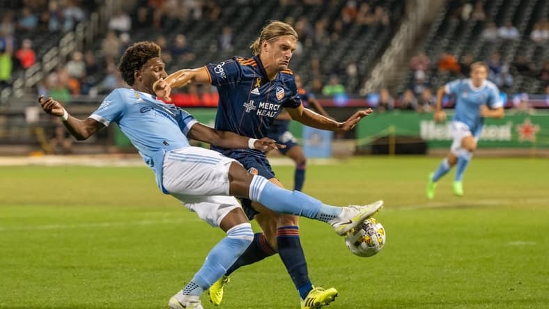 Sep 7, 2022; New York, NY, New York, NY, USA; New York City FC forward Talles Magno (43) crosses the ball defended by FC Cincinnati defender Nick Hagglund (4) during the first half at Citi Field. Mandatory Credit: Mark Smith-USA TODAY Sports