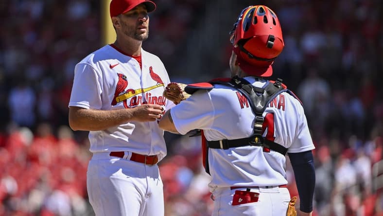Sep 8, 2022; St. Louis, Missouri, USA; St. Louis Cardinals starting pitcher Adam Wainwright (50) talks with catcher Yadier Molina (4) during the fifth inning against the Washington Nationals at Busch Stadium. Mandatory Credit: Jeff Curry-USA TODAY Sports