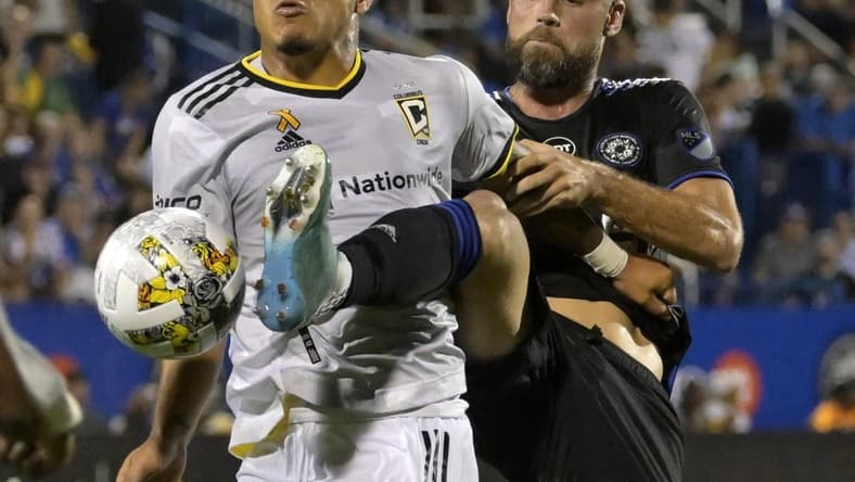 Sep 9, 2022; Montreal, Quebec, CAN; CF Montreal defender Rudy Camacho (4) kicks the ball away from Columbus Crew forward Cucho Suarez (9) during the first half at Stade Saputo. Mandatory Credit: Eric Bolte-USA TODAY Sports