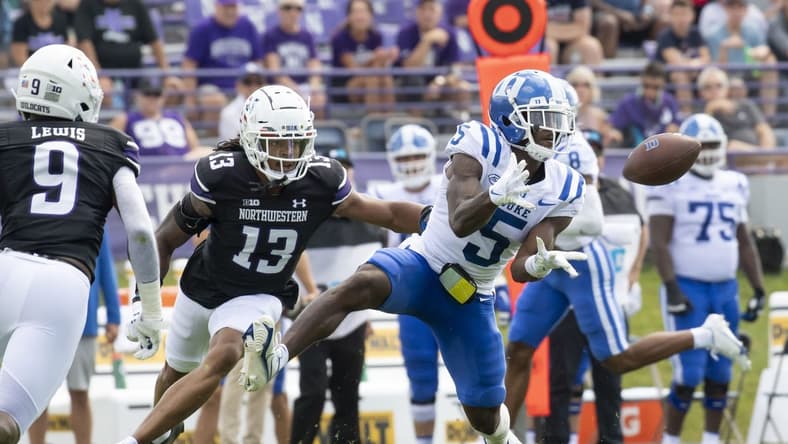 Sep 10, 2022; Evanston, Illinois, USA; Duke Blue Devils wide receiver Jalon Calhoun (5) receives a pass against Northwestern Wildcats defensive back Garnett Hollis Jr. (13) during the first quarter at Ryan Field. Mandatory Credit: Patrick Gorski-USA TODAY Sports
