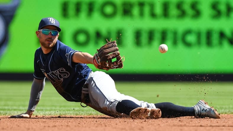 Sep 10, 2022; Bronx, New York, USA; Tampa Bay Rays second baseman Brandon Lowe (8) makes a diving catch and flips the ball to Tampa Bay Rays infielder Wander Franco (5) (not pictured) against the New York Yankees during the first inning at Yankee Stadium. Mandatory Credit: Dennis Schneidler-USA TODAY Sports