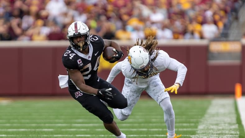 Sep 10, 2022; Minneapolis, Minnesota, USA; Minnesota Golden Gophers running back Mohamed Ibrahim (24) evades  by Western Illinois Leathernecks defensive back Corey Scott (24) in the second quarter at Huntington Bank Stadium. Mandatory Credit: Matt Blewett-USA TODAY Sports