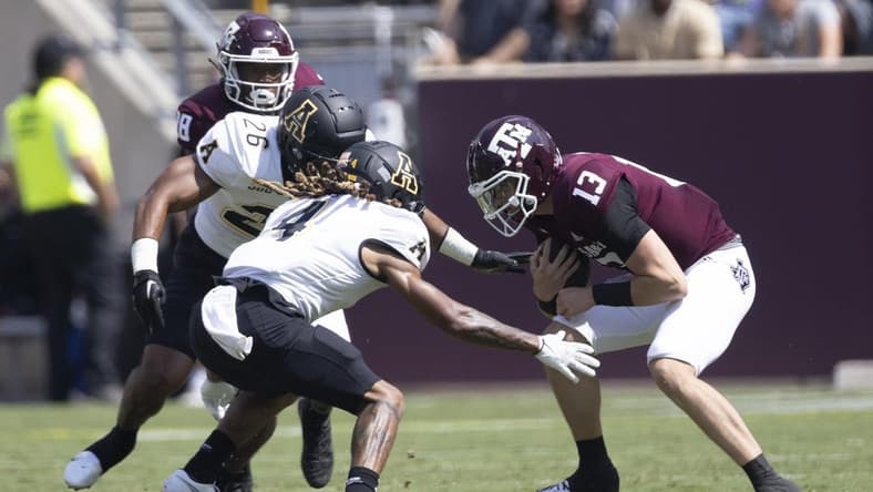 Sep 10, 2022; College Station, Texas, USA;Texas A&M Aggies quarterback Haynes King (13) is tackled by Appalachian State Mountaineers defensive back Nick Ross (4) in the second quarter at Kyle Field. Mandatory Credit: Thomas Shea-USA TODAY Sports