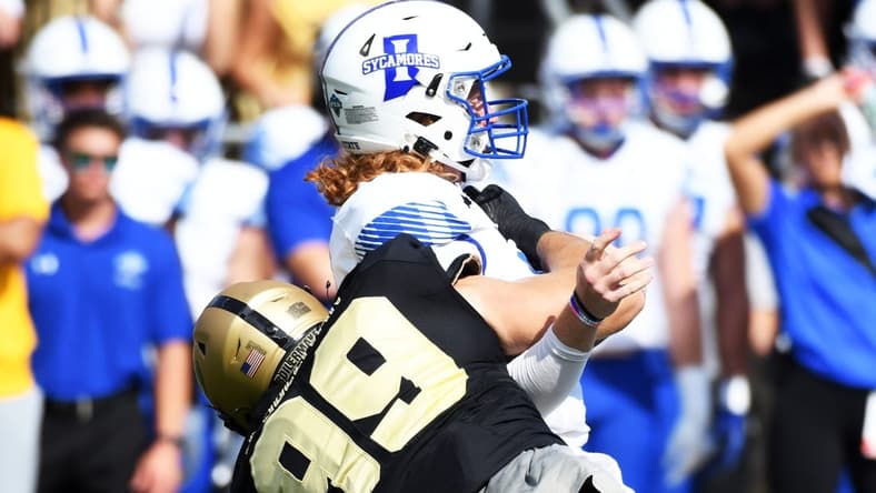 Sep 10, 2022; West Lafayette, Indiana, USA;  Indiana State Sycamores quarterback Gavin Screws (10) is sacked by Purdue Boilermakers defensive end Jack Sullivan (99) during the first quarter against the Purdue Boilermakers at Ross-Ade Stadium. Mandatory Credit: Robert Goddin-USA TODAY Sports