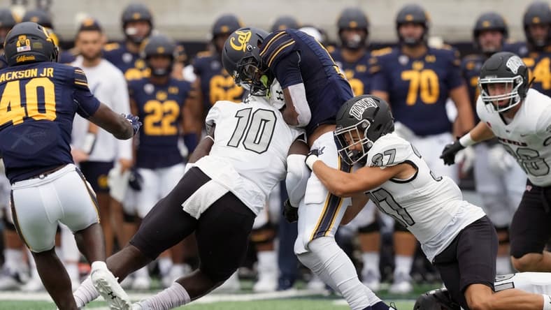 Sep 10, 2022; Berkeley, California, USA; UNLV Rebels linebacker Fred Thompkins (10) hits California Golden Bears wide receiver Jeremiah Hunter (3) as defensive back Davone Walden Jr. (37) tackles during the second quarter at FTX Field at California Memorial Stadium. Mandatory Credit: Darren Yamashita-USA TODAY Sports