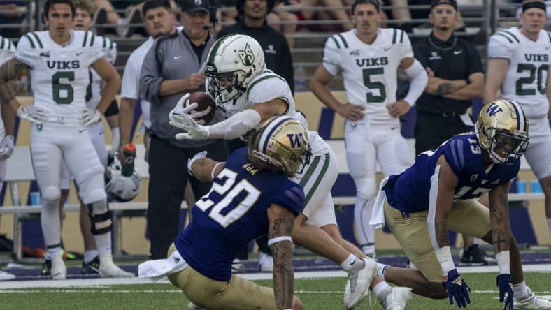 Sep 10, 2022; Seattle, Washington, USA; Portland State Vikings wide receiver Beau Kelly (13) escapes the grasp of Washington Huskies defensive back Asa Turner (20) and linebacker Kamren Fabiculanan (13) after a reception during the first half at Alaska Airlines Field at Husky Stadium. Mandatory Credit: Stephen Brashear-USA TODAY Sports