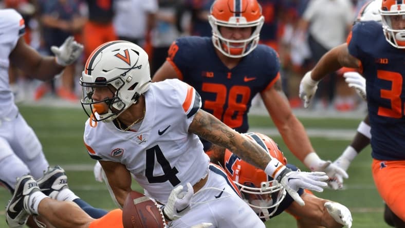 Sep 10, 2022; Champaign, Illinois, USA; Virginia Cavaliers wide receiver Dontayvion Wicks (3) rubles the ball on a tackle by Illinois Fighting Illini defensive back Sydney Brown (30) in the first half at Memorial Stadium. Mandatory Credit: Ron Johnson-USA TODAY Sports