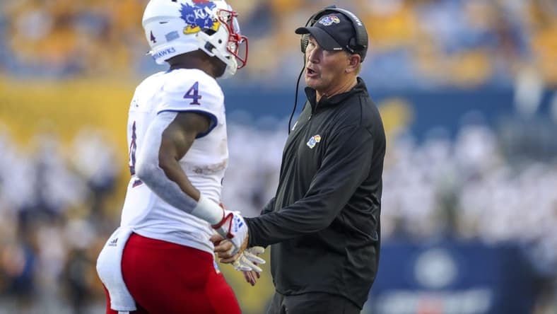 Sep 10, 2022; Morgantown, West Virginia, USA; Kansas Jayhawks head coach Lance Leipold talks to running back Devin Neal (4) during the second quarter against the West Virginia Mountaineers at Mountaineer Field at Milan Puskar Stadium. Mandatory Credit: Ben Queen-USA TODAY Sports