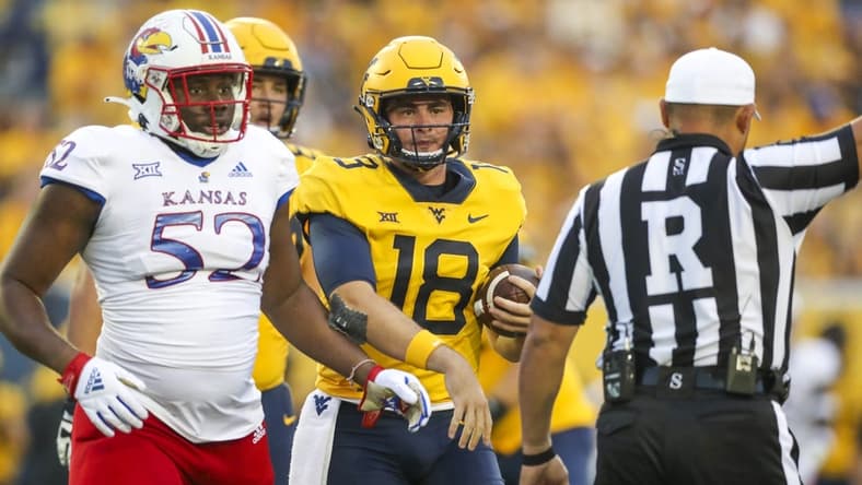 Sep 10, 2022; Morgantown, West Virginia, USA; West Virginia Mountaineers quarterback JT Daniels (18) reacts after a penalty during the second quarter against the Kansas Jayhawks at Mountaineer Field at Milan Puskar Stadium. Mandatory Credit: Ben Queen-USA TODAY Sports