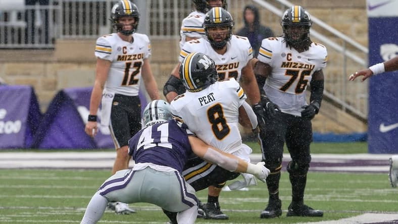 Sep 10, 2022; Manhattan, Kansas, USA; Missouri Tigers running back Nathaniel Peat (8) is tackled by Kansas State Wildcats linebacker Austin Moore (41) during the fourth quarter at Bill Snyder Family Football Stadium. Mandatory Credit: Scott Sewell-USA TODAY Sports