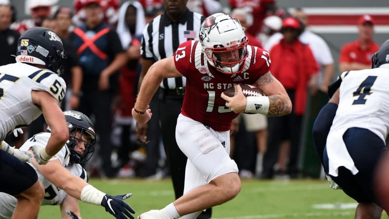 Sep 10, 2022; Raleigh, North Carolina, USA; North Carolina State Wolfpack quarterback Devin Leary (13) runs  for a touchdown during the first half against the Charleston Southern Buccaneers at Carter-Finley Stadium. Mandatory Credit: Rob Kinnan-USA TODAY Sports