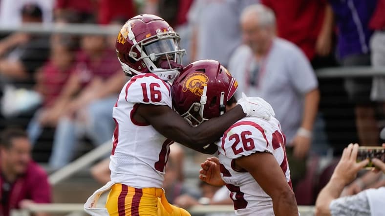 Sep 10, 2022; Stanford, California, USA;  USC Trojans wide receiver Tahj Washington (16) and running back Travis Dye (26) celebrate during the second quarter against the Stanford Cardinal at Stanford Stadium. Mandatory Credit: Stan Szeto-USA TODAY Sports