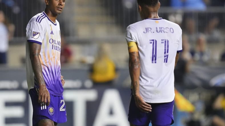 Sep 10, 2022; Chester, Pennsylvania, USA; Orlando City defender Antonio Carlos (25) and midfielder Junior Urso (11) look on after a goal by the Philadelphia Union in the second half at Subaru Park. Mandatory Credit: Mitchell Leff-USA TODAY Sports