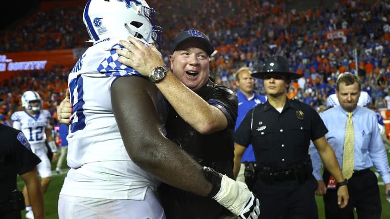 Sep 10, 2022; Gainesville, Florida, USA; Kentucky Wildcats head coach Mark Stoops and offensive lineman Tashawn Manning (79) celebrate after they beat the Florida Gators at Ben Hill Griffin Stadium. Mandatory Credit: Kim Klement-USA TODAY Sports