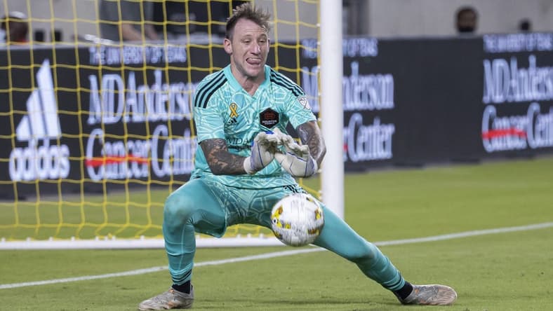 Sep 10, 2022; Houston, Texas, USA; Houston Dynamo FC goalkeeper Steve Clark (12) defects a shot during stoppage time in the second half against the Sporting Kansas City at PNC Stadium. Mandatory Credit: Troy Taormina-USA TODAY Sports