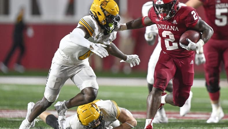 Sep 10, 2022; Bloomington, Indiana, USA; Indiana Hoosiers running back Shaun Shivers (2) stiff arms Idaho Vandals defensive back Murvin Kenion III (0) during the second half at Memorial Stadium. The Hoosiers won 35-22. Mandatory Credit: Marc Lebryk-USA TODAY Sports