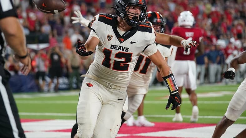 Sep 10, 2022; Fresno, California, USA; Oregon State Beavers running back Jack Colletto (12) flips the ball to an official after scoring a touchdown against the Fresno State Bulldogs on the final play of the game at Valley Children's Stadium. Mandatory Credit: Cary Edmondson-USA TODAY Sports