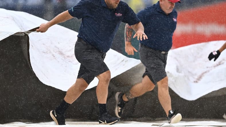Sep 11, 2022; Philadelphia, Pennsylvania, USA; Phillies Grounds Crew cover the field during a rain delay during the game between the Philadelphia Phillies and Washington Nationals at Citizens Bank Park. Mandatory Credit: Kyle Ross-USA TODAY Sports