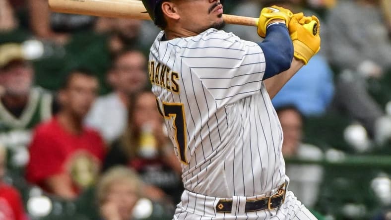 Sep 11, 2022; Milwaukee, Wisconsin, USA; Milwaukee Brewers shortstop Willy Adames (27) hits a 2-run home run in the second inning against the Cincinnati Reds at American Family Field. Mandatory Credit: Benny Sieu-USA TODAY Sports