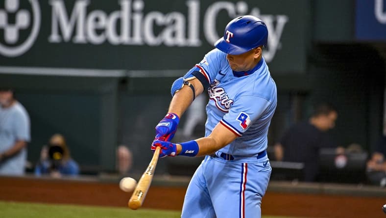 Sep 11, 2022; Arlington, Texas, USA; Texas Rangers first baseman Nathaniel Lowe (30) hits a single and drives in a run against the Toronto Blue Jays during the first inning at Globe Life Field. Mandatory Credit: Jerome Miron-USA TODAY Sports