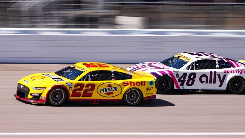 Sep 11, 2022; Kansas City, Kansas, USA; NASCAR Cup Series driver Joey Logano (22) leads driver Alex Bowman (48) during the Hollywood Casino 400 at Kansas Speedway. Mandatory Credit: Jay Biggerstaff-USA TODAY Sports