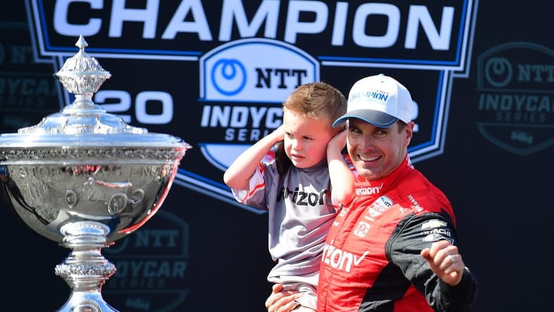 Sep 11, 2022; Salinas, California, USA; Team Penske driver Will Power (12) of Australia with son Beau William celebrates his series victory following the Grand Prix of Monterey at WeatherTech Raceway Laguna Seca. Mandatory Credit: Gary A. Vasquez-USA TODAY Sports