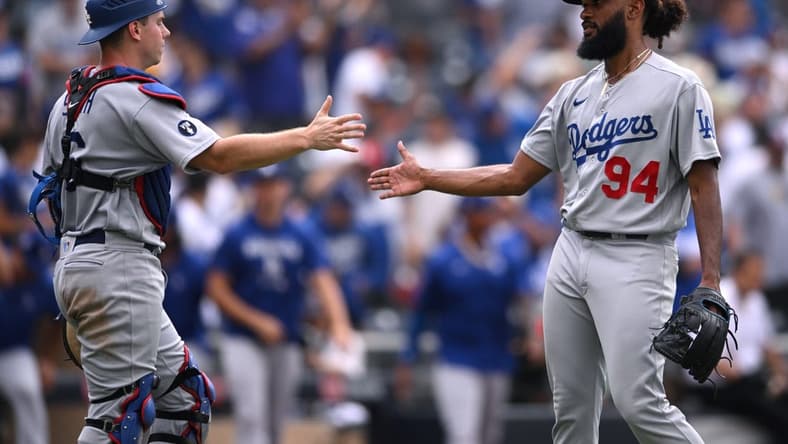 Sep 11, 2022; San Diego, California, USA; Los Angeles Dodgers relief pitcher Andre Jackson (94) and catcher Will Smith (left) celebrate after defeating the San Diego Padres at Petco Park. Mandatory Credit: Orlando Ramirez-USA TODAY Sports
