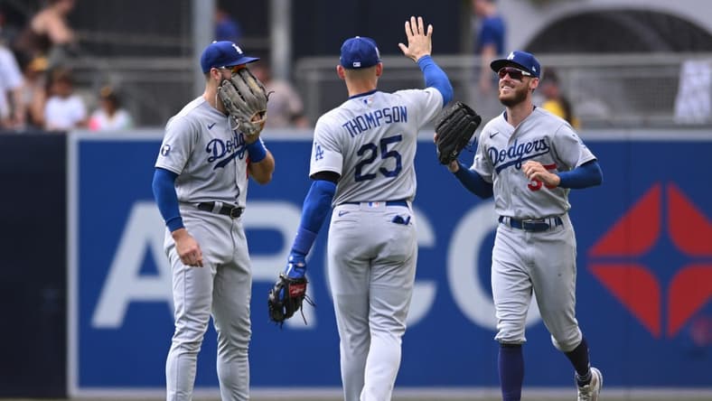 Sep 11, 2022; San Diego, California, USA; Los Angeles Dodgers right fielder Trayce Thompson (25) celebrates with center fielder Cody Bellinger (35) and left fielder Joey Gallo (12) after defeating the San Diego Padres at Petco Park. Mandatory Credit: Orlando Ramirez-USA TODAY Sports