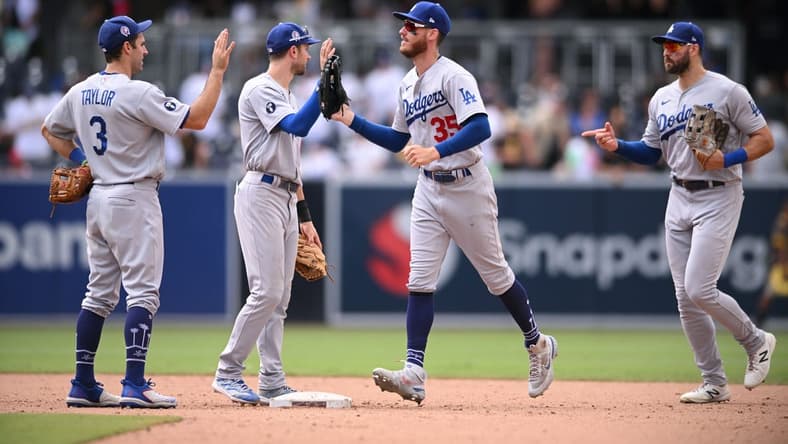 Sep 11, 2022; San Diego, California, USA; Los Angeles Dodgers players celebrate on the field after defeating the San Diego Padres at Petco Park. Mandatory Credit: Orlando Ramirez-USA TODAY Sports