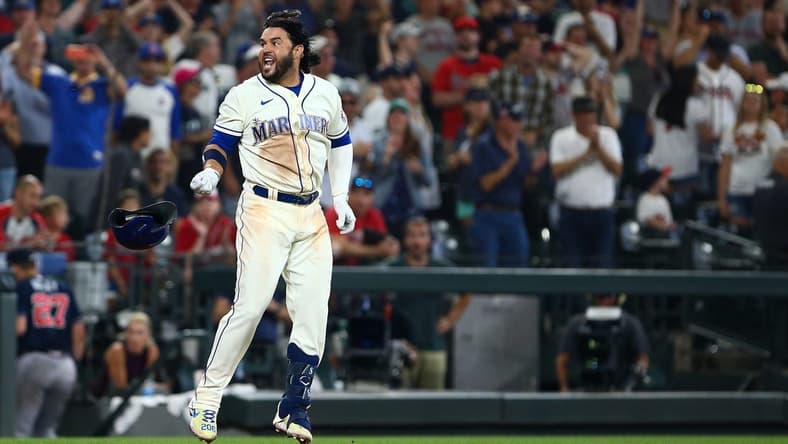 Sep 11, 2022; Seattle, Washington, USA; Seattle Mariners third baseman Eugenio Suarez (28) throws his helmet as he celebrates his walk-off home run to beat the Atlanta Braves during the ninth inning at T-Mobile Park. The Mariners beat the Braves 8-7. Mandatory Credit: Lindsey Wasson-USA TODAY Sports