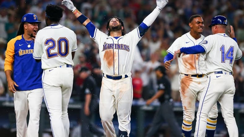 Sep 11, 2022; Seattle, Washington, USA; Seattle Mariners third baseman Eugenio Suarez (28,center) celebrates after hitting a walk-off solo home run to beat the Atlanta Braves during the ninth inning at T-Mobile Park. The Mariners beat the Braves 8-7. Mandatory Credit: Lindsey Wasson-USA TODAY Sports