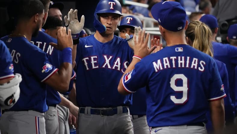 Sep 12, 2022; Miami, Florida, USA; Texas Rangers shortstop Corey Seager (5) celebrates his two-run home run against the Miami Marlins in the seventh inning with teammates at loanDepot park. Mandatory Credit: Jasen Vinlove-USA TODAY Sports