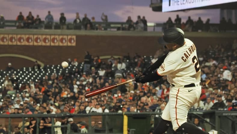 Sep 12, 2022; San Francisco, California, USA; San Francisco Giants designated hitter Willie Calhoun (2) hits an RBI single against the Atlanta Braves during the second inning at Oracle Park. Mandatory Credit: Kelley L Cox-USA TODAY Sports