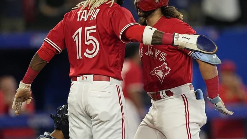 Sep 12, 2022; Toronto, Ontario, CAN; Toronto Blue Jays shortstop Bo Bichette (11) celebrates his two run home run with left fielder Raimel Tapia (15) against the Tampa Bay Rays during the eighth inning at Rogers Centre. Mandatory Credit: John E. Sokolowski-USA TODAY Sports