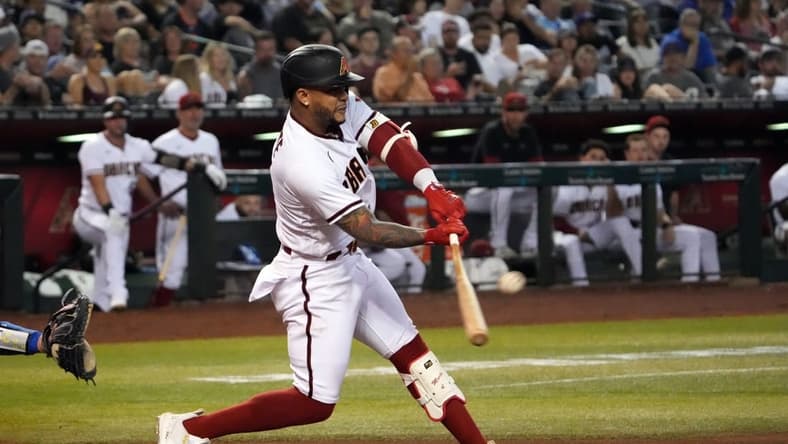 Sep 12, 2022; Phoenix, Arizona, USA; Arizona Diamondbacks second baseman Ketel Marte (4) hits a double against the Los Angeles Dodgers during the sixth inning at Chase Field. Mandatory Credit: Joe Camporeale-USA TODAY Sports