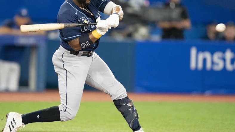 Sep 13, 2022; Toronto, Ontario, CAN; Tampa Bay Rays third baseman Yandy Diaz (2) hits a single against the Toronto Blue Jays during the third inning at Rogers Centre. Mandatory Credit: Nick Turchiaro-USA TODAY Sports