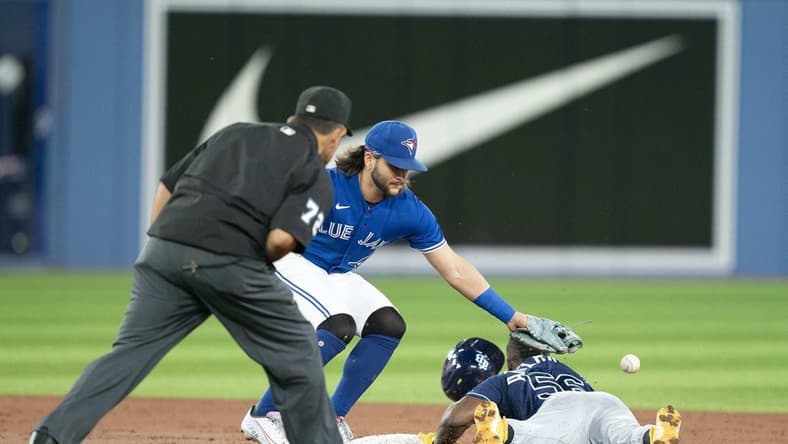 Sep 13, 2022; Toronto, Ontario, CAN; Tampa Bay Rays right fielder Randy Arozarena (56) steals second base ahead of the tag from Toronto Blue Jays shortstop Bo Bichette (11) during the third inning at Rogers Centre. Mandatory Credit: Nick Turchiaro-USA TODAY Sports