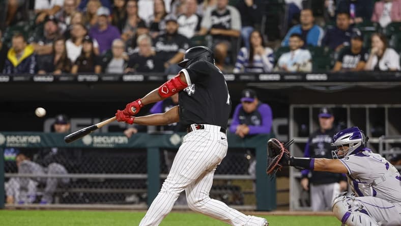 Sep 13, 2022; Chicago, Illinois, USA; Chicago White Sox left fielder Eloy Jimenez (74) hits a three-run home run against the Colorado Rockies during the first inning at Guaranteed Rate Field. Mandatory Credit: Kamil Krzaczynski-USA TODAY Sports