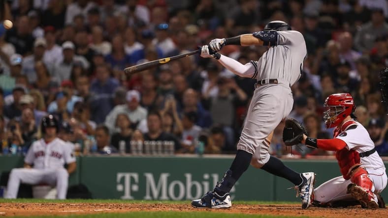 Sep 13, 2022; Boston, Massachusetts, USA; New York Yankees center fielder Aaron Judge (99) hits a home run during the sixth inning against the Boston Red Sox at Fenway Park. Mandatory Credit: Paul Rutherford-USA TODAY Sports