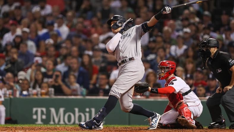 Sep 13, 2022; Boston, Massachusetts, USA; New York Yankees center fielder Aaron Judge (99) hits a home run during the eighth inning against the Boston Red Sox at Fenway Park. Mandatory Credit: Paul Rutherford-USA TODAY Sports