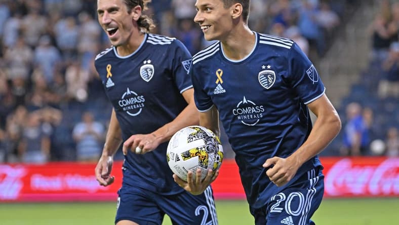 Sep 13, 2022; Kansas City, Kansas, USA; Sporting Kansas City forward Daniel Salloi (20) reacts after scoring a goal against D.C. United during the second half at Children's Mercy Park. Mandatory Credit: Peter Aiken-USA TODAY Sports