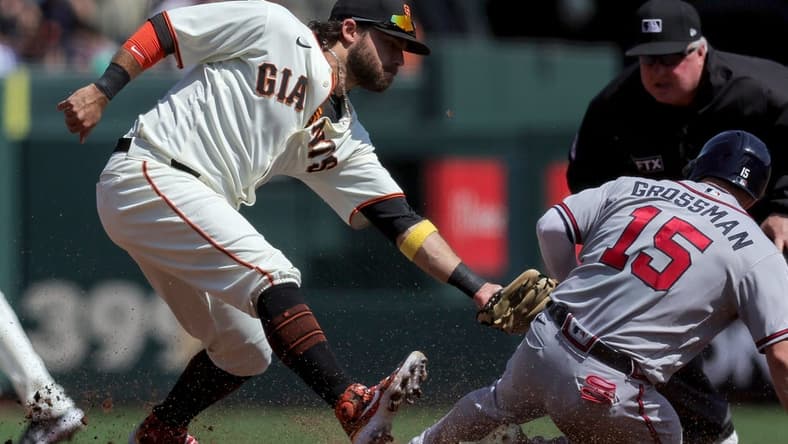 Sep 14, 2022; San Francisco, California, USA; Atlanta Braves left fielder Robbie Grossman (15) is tagged out at second base by San Francisco Giants shortstop Brandon Crawford (35) during the third inning at Oracle Park. Mandatory Credit: Sergio Estrada-USA TODAY Sports