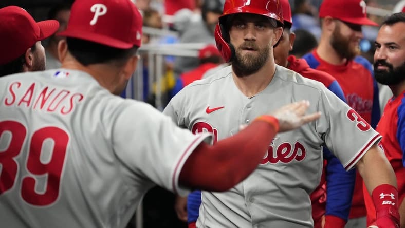 Sep 14, 2022; Miami, Florida, USA; Philadelphia Phillies designated hitter Bryce Harper (3) celebrates in the dugout after hitting a solo home run in the sixth inning against the Miami Marlins at loanDepot park. Mandatory Credit: Jasen Vinlove-USA TODAY Sports