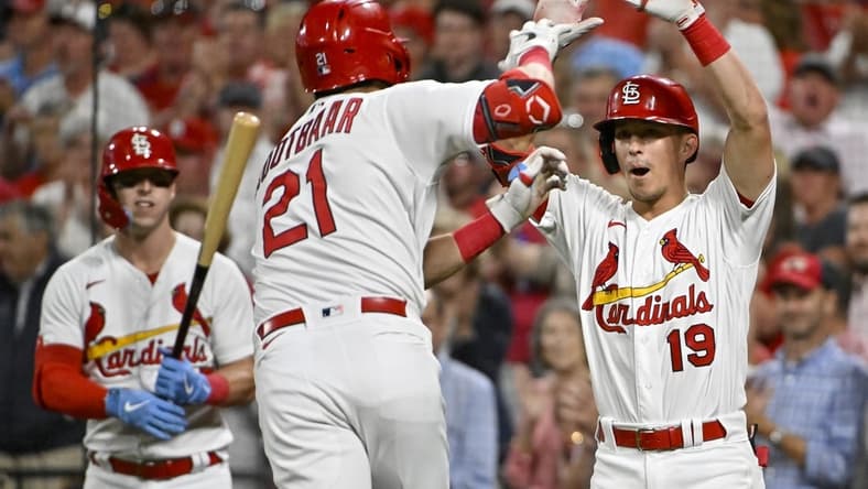 Sep 14, 2022; St. Louis, Missouri, USA;  St. Louis Cardinals center fielder Lars Nootbaar (21) is congratulated by second baseman Tommy Edman (19) after hitting a solo home run against the Milwaukee Brewers during the fifth inning at Busch Stadium. Mandatory Credit: Jeff Curry-USA TODAY Sports