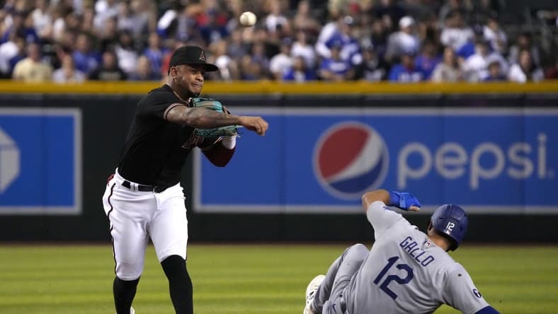Sep 14, 2022; Phoenix, Arizona, USA; Arizona Diamondbacks second baseman Ketel Marte (4) gets the force out on Los Angeles Dodgers left fielder Joey Gallo (12) in the fourth inning at Chase Field. Mandatory Credit: Rick Scuteri-USA TODAY Sports